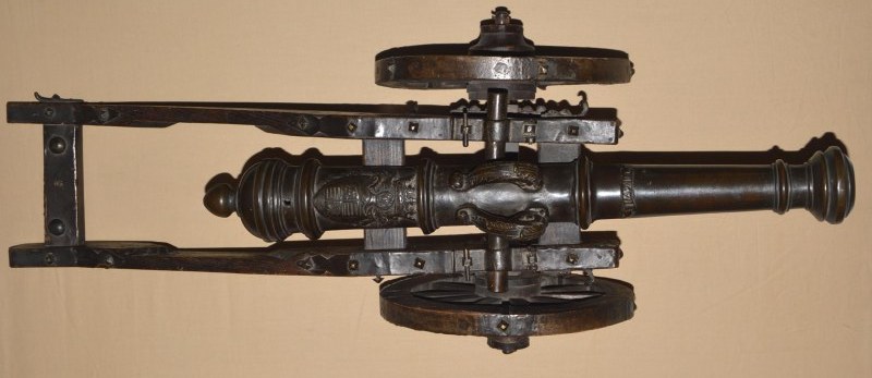 A pair of model cannons, German, circa 1700. Bronze barrels in several  sections with hoop structure and reinforced muzzles. Side mounted  trunnions. There are two sculpted hooks in the shape of dolphins